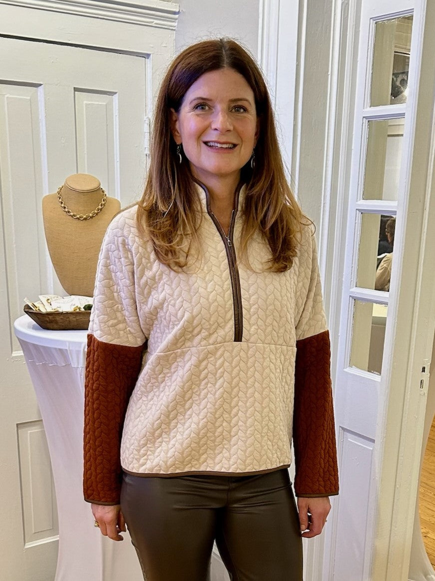 Our Contrasting Half Zip Textured Quilted Top is so cozy and comfy. The beige color and rust colored sleeves paired with dark brown faux leather trim give this top a trendy look. The stand up collar and half zip add functional style to this great transition piece.

Material: 97% Polyester / 3% Spandex

Care Instructions: Gentle cool hand wash, dry flat