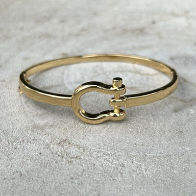This fun hinged bracelet featuring a distinctive stirrup-shaped accent, crafted for those with a passion for equestrian style. Available in lustrous gold and silver finishes, this piece combines timeless sophistication with a nod to classic horsemanship. The smooth hinge mechanism ensures comfortable wear, while the refined stirrup detail adds character and conversation appeal.&nbsp;

Note: Silver N' Accessories jewelry is brass and stainless steel with rhodium and 18 KT gold plated. It's water resistant an