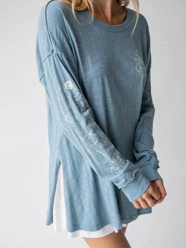 Embrace effortless style with this oversized cotton tee that combines comfort and creativity. The light blue base serves as a canvas for playful artistic doodles that make every wear feel fresh and expressive. Crafted from 100% soft cotton, this relaxed-fit essential features raw edge details and flattering side slits for an on-trend silhouette. Perfect for casual days, layering, or making a statement on its own.

Size/Measurements:

Small
Length: 28in (from highest point on shoulder); Chest: 40in
Generousl