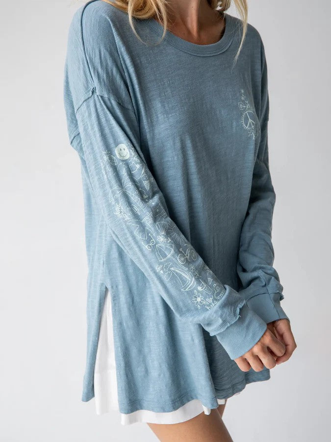 Embrace effortless style with this oversized cotton tee that combines comfort and creativity. The light blue base serves as a canvas for playful artistic doodles that make every wear feel fresh and expressive. Crafted from 100% soft cotton, this relaxed-fit essential features raw edge details and flattering side slits for an on-trend silhouette. Perfect for casual days, layering, or making a statement on its own.

Size/Measurements:

Small
Length: 28in (from highest point on shoulder); Chest: 40in
Generousl