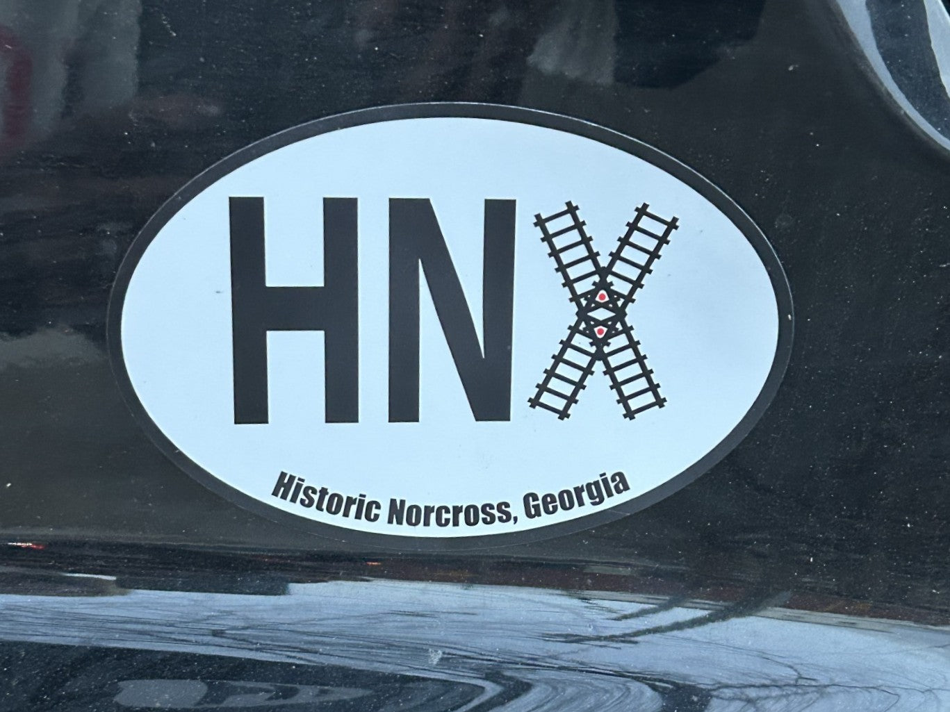 Celebrate the charm of Historic Norcross with this distinctive oval-shaped magnet featuring the beloved train tracks logo. Perfect for displaying on your refrigerator, locker, or any magnetic surface, this magnet is more than just a decorative piece—it's a statement of community pride. By choosing this product, you're directly supporting local Norcross businesses and initiatives that keep our town's rich heritage alive. Whether you're a longtime resident or a visitor who fell in love with our historic downt