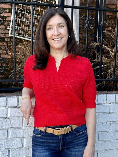 Cheer in style with this bold red open knit sweater designed for game day and beyond. The V-neckline flatters every frame, while the distinctive ruffled collar adds personality and flair. Its airy, slightly open weave construction ensures you stay comfortable whether you're in the stands or out on the town. Short sleeves make it easy to layer or wear solo, giving you a versatile piece that works hard for your wardrobe all season long.

Tara is wearing a size Medium.

Material:&nbsp; 43% Viscose / 32% Nylon 