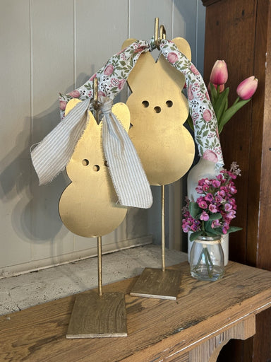 Bring springtime charm to your home with these delightful hanging metal bunnies. Crafted from durable metal with adorable ribbon accents, they're perfect for Easter displays or refreshing your spring décor. Lightweight and easy to hang, these bunnies add a festive touch to any room, porch, or garden space. Celebrate the season with timeless appeal that welcomes guests with warmth and personality.

Approximate Dimensions:

Small: 3 x 6
Medium: 4 x 8
Large: 5 x 10