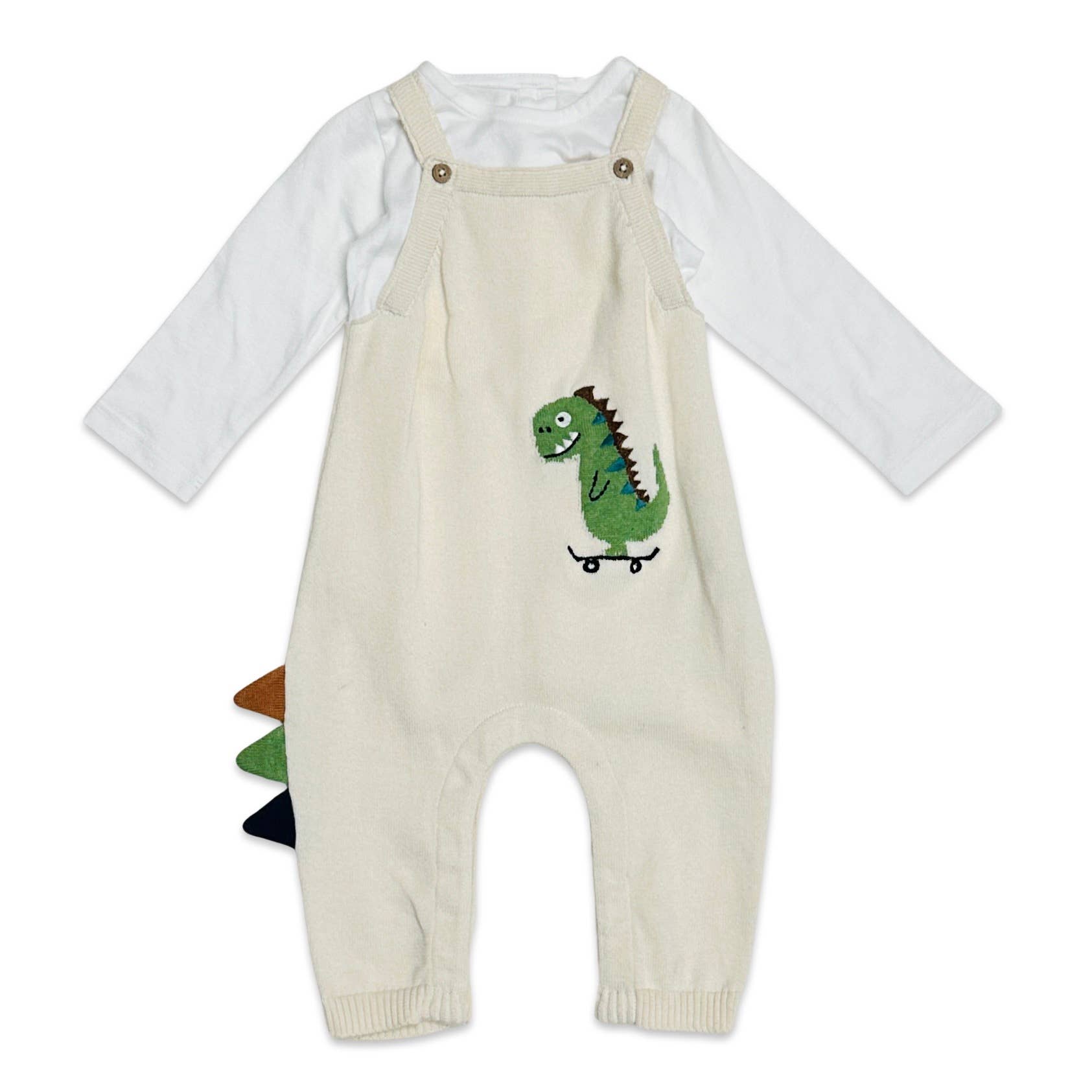 <p>Introducing our adorable Dino Jacquard Knit Baby Overall Set! Made from 100% organic cotton, this ultra-soft romper features an embroidered dinosaur on the front. The sides even have cute dinosaur spikes that add an extra touch of charm. Natural in color and perfect for all seasons, this lightweight overall set is a must-have for any stylish baby's wardrobe.</p> <p>Ethically produced in India, supporting better livelihoods for small grower farmers. 100% Organic Cotton. 