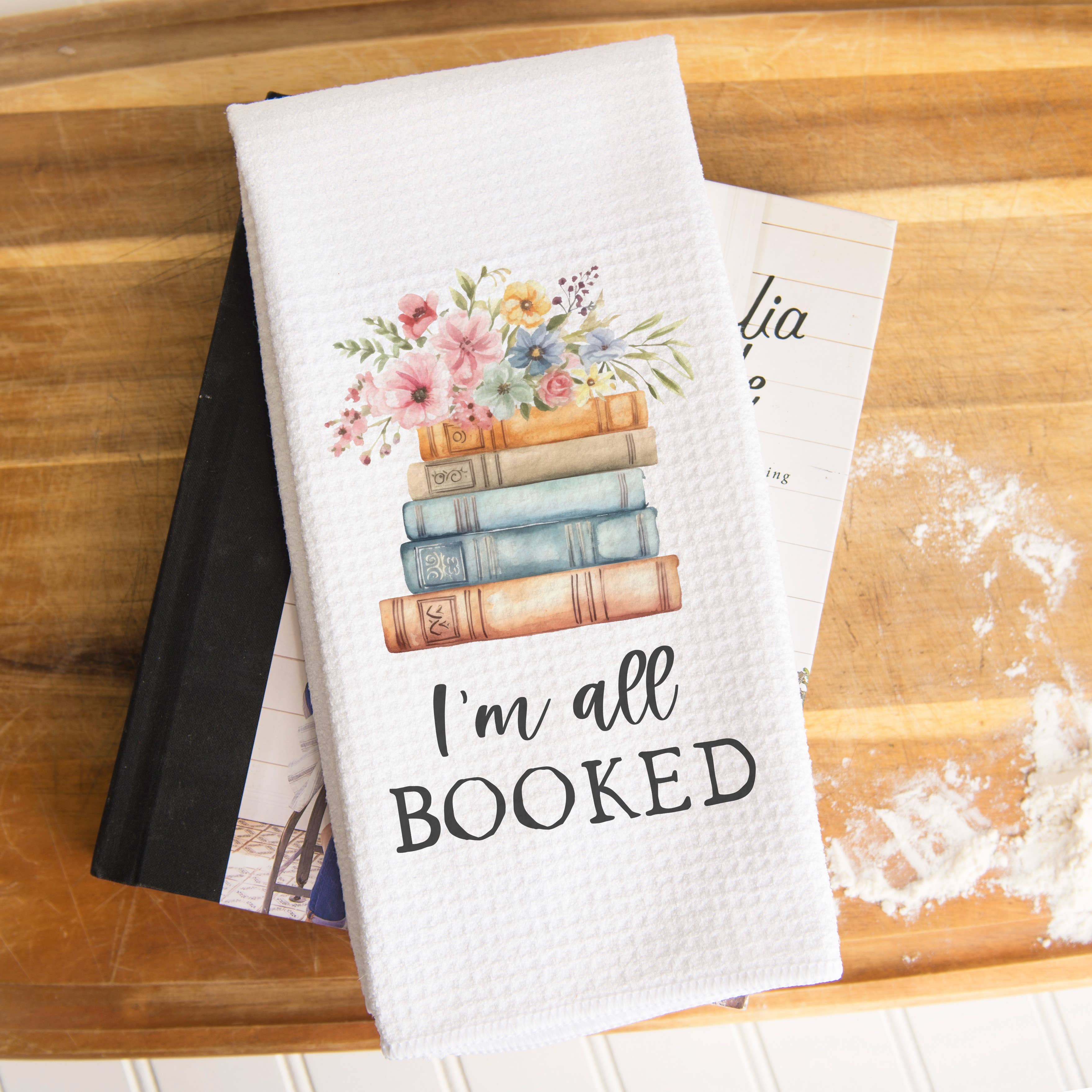 Celebrate your love of reading with the "I'm All Booked" kitchen towel. Its charming floral book design makes it a perfect gift for friends, family, book clubs, or any avid reader. Crafted with a waffle weave, this towel offers exceptional absorbency and quick drying, making it both practical and stylish. Add a literary touch to your kitchen decor while keeping your dishes spotless with this delightful tea towel.

Size: 16" x 24"

Material: 80% Polyester / 20% Polyamide