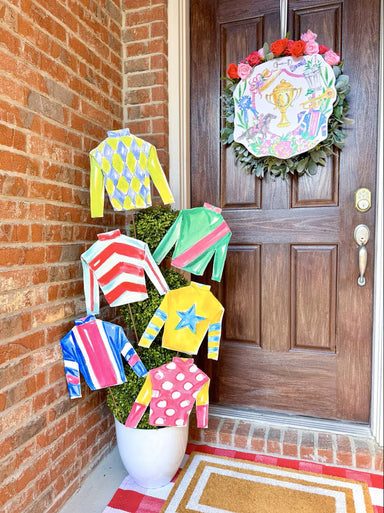 Celebrate the excitement of horse racing with these vibrant Jockey Silks Stakes. Featuring the iconic colorful patterns inspired by classic racing silks, these outdoor garden stakes add a touch of equestrian charm to any landscape. Perfect for derby season or year-round display, they're designed to hang (or stake) and showcase your love of horses and racing tradition. A unique accent piece for garden enthusiasts and racing fans alike.

Dimensions: 13" x .5" x 12"