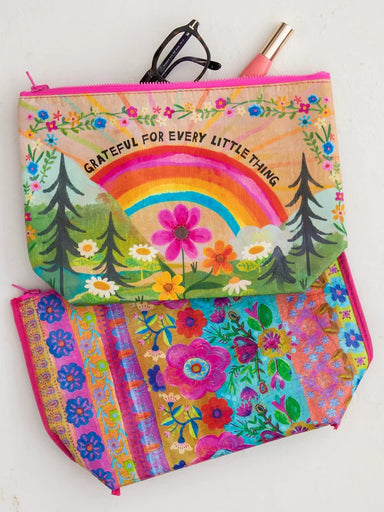 Sustainable style meets everyday practicality with this reversible zipper pouch crafted from recycled water bottles. Flip it to match your mood—one side features inspiring words and cheerful artwork, while the other showcases a fun print. Compact yet spacious, it's ideal for organizing essentials in your tote, backpack, or luggage. A small choice that makes a big environmental impact.

Measurements: 12in L x 8.5in H, 3in W bottom gusset

Material &amp; Care:&nbsp;

rPET, made with 80% recycled plastic water