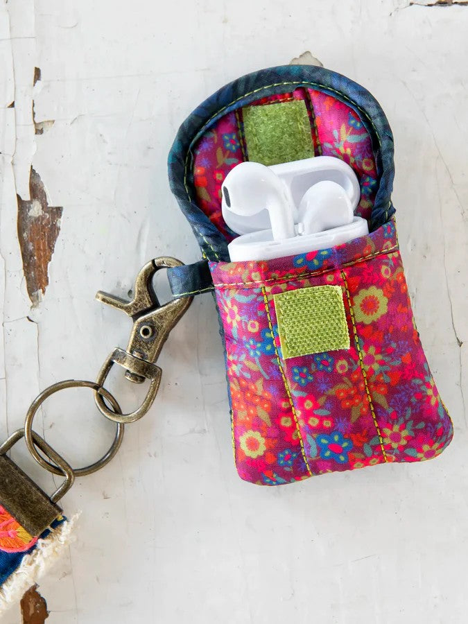 Protect your earbuds in style with this vibrant, puffy case featuring eye-catching mixed prints. The convenient Velcro flap closure keeps your earbuds secure and tangle-free, while the attached keychain loop makes it easy to carry wherever you go. Say goodbye to lost or damaged earbuds—this adorable case has you covered.

Dimensions:&nbsp;3.75in L x 3.25in W

Material &amp; Care:

100% polyester
Spot Clean Only With A Damp Cloth