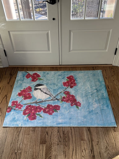 Our Bamboo Floor Mats are the perfect way to add a touch of Spring to your home. With beautiful, floral designs, they'll brighten up any space. Durable and stylish, our mats are the perfect addition for your door or floor. Let the Spring season shine!  Care Instructions: Use a wet cloth or Swiffer mop. Do not saturate the mat due to the felt on the bottom. 