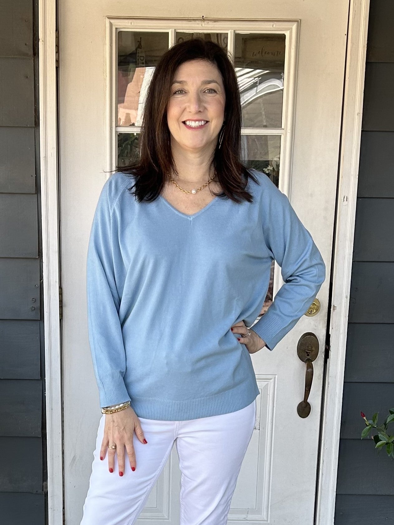 Transition effortlessly between seasons with our Camelia V-Neck Sweater! The lightweight design and stunning sky blue color make it perfect for spring, summer, and fall. Plus, the V-neck and banded cuffs and waist add a stylish touch to the classic raglan sleeve.&nbsp;  One size fits most.  Material: 52% Viscose / 24% Polyamide / 20% Polyester / 4% Elastan