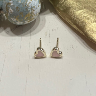 Feel the love and radiate sweetness with our Cherish Stud Earrings. These dainty earrings feature a pale pink center heart, perfect for adding a touch of charm to any outfit. With their post design, they are easy to wear and sure to become a lovely addition to your jewelry collection.