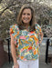 <p>Such a beautiful, colorful top! Featuring dramatic colors and a ruffled neck, it's perfect for adding a pop of color to any outfit. The beautifully draped cap sleeves and V-neck add a touch of elegance. Pair it with your favorite white jeans for a stylish and vibrant look!</p> <p>Material: 85% Rayon / 15% Nylon</p> <p>Care Instructions: Hand wash cool, dry flat</p>