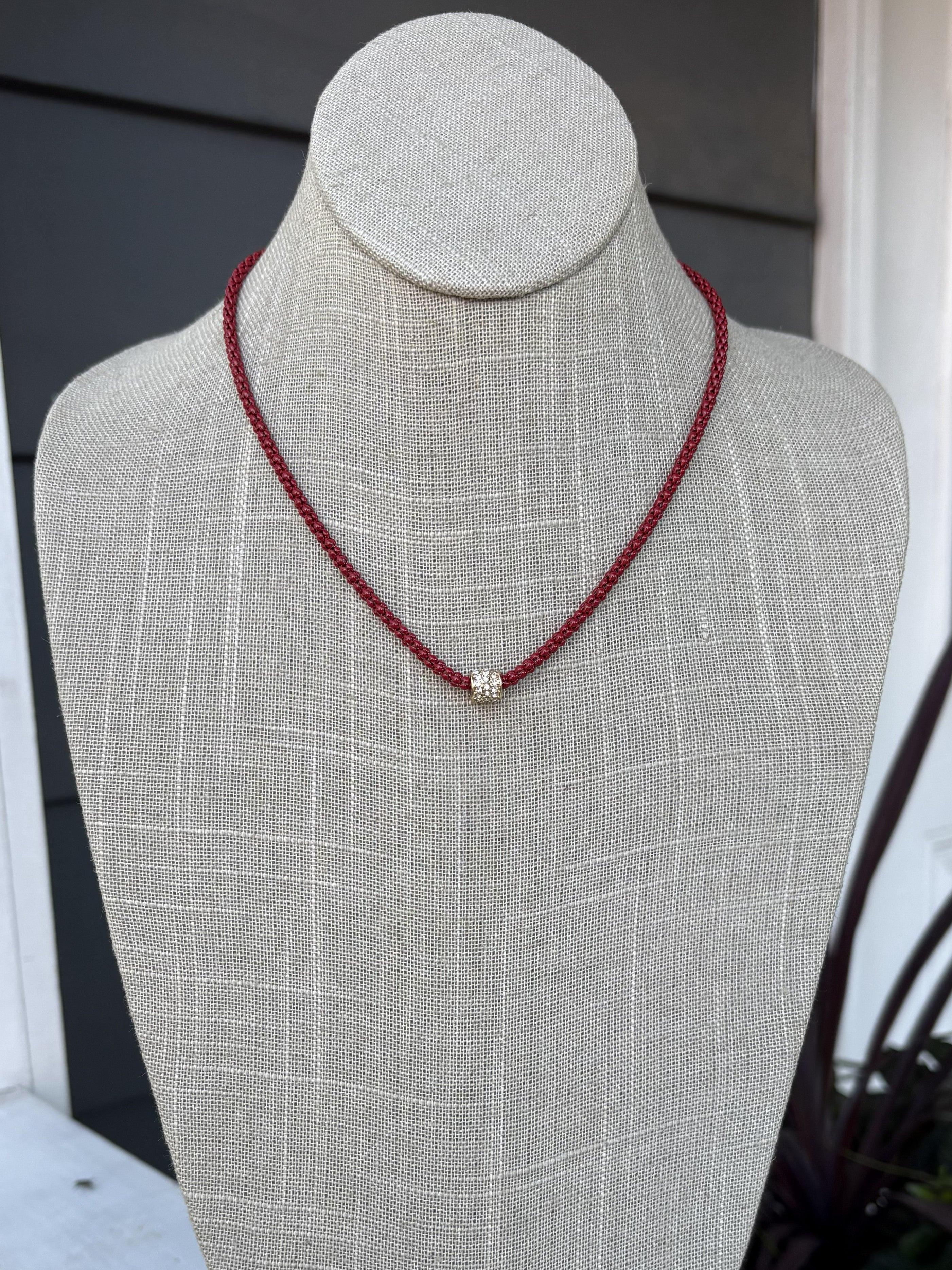 Cheer in confidence with the Cassie Game Day Necklace. This short, striking piece features a rhinestone tube charm. Perfect for game day enthusiasts, it pairs effortlessly with team colors and casual wear alike. Lightweight, eye-catching, and designed to be your go-to accessory for every victory lap.