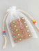 Add a touch of elegance to your workspace with these 20 rhinestone flower push pins. Each pin showcases a stunning rhinestone-adorned flower that instantly upgrades any bulletin board or inspiration wall. Presented on natural cork backing and nestled in a delicate organza bag, this set makes a thoughtful gift for anyone seeking functional beauty. Ideal for personalizing dorms, home offices, or creative spaces with a sophisticated flair.

Details:

Set of 20 rhinestone flower decorative push pins
Displayed o