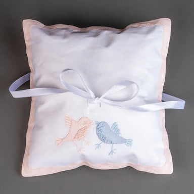 Celebrate your special day with this charming white ring bearer pillow, adorned with delicate hand-embroidered robins in soft pink, and blue hues. Each bird is meticulously stitched to create a sweet, romantic aesthetic that adds a personal touch to your ceremony. Designed with secure ties to safely hold your rings, this pillow combines functionality with artistic beauty. Perfect for a meaningful keepsake, it brings warmth and elegance to any wedding celebration.

Size: 7x7

Care Instructions: Machine Wash 