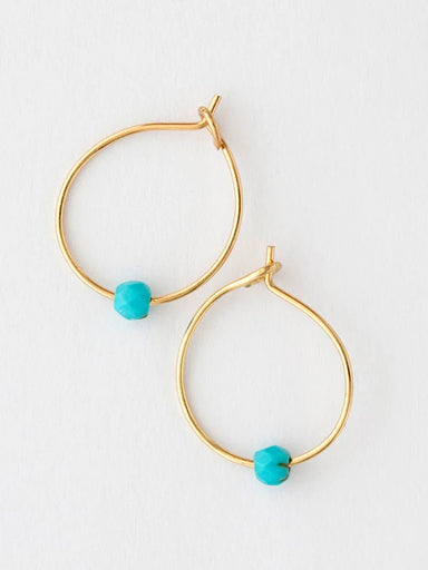 Tiny but mighty, these turquoise hoops pack personality into a lightweight design. The soft turquoise stone pairs perfectly with warm gold accents, creating an effortless look that transitions from day to night. Supremely comfortable for all-day wear, they're ideal for stacking or wearing solo. A versatile essential that brings just the right touch of color to any ensemble.

Details:

hypoallergenic copper, real gemstones
.5in diameter