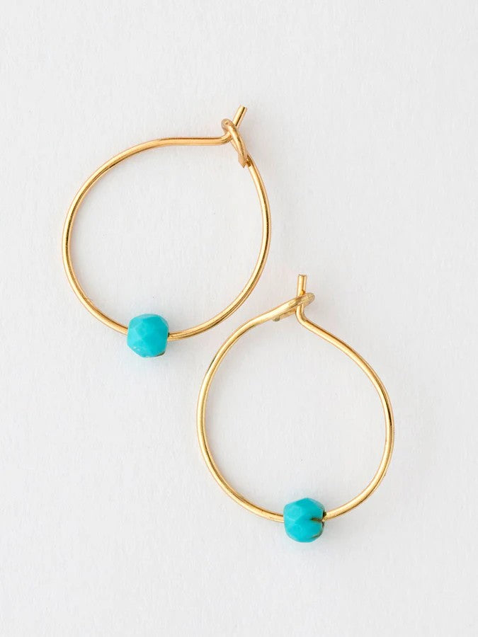 Tiny but mighty, these turquoise hoops pack personality into a lightweight design. The soft turquoise stone pairs perfectly with warm gold accents, creating an effortless look that transitions from day to night. Supremely comfortable for all-day wear, they're ideal for stacking or wearing solo. A versatile essential that brings just the right touch of color to any ensemble.

Details:

hypoallergenic copper, real gemstones
.5in diameter
