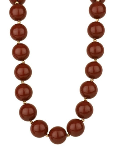 This Brown Beaded Necklace features substantial 20 mm beads in a rich, warm brown tone that brings depth and texture to any look. The generous bead size creates natural dimension. Versatile and timeless, adding warmth and character to your everyday style.

Length: 18"