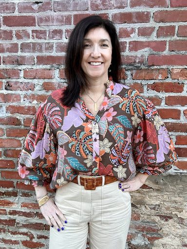 Experience the beauty of nature with our Floral Puffed Sleeve Top! Adorned with gorgeous earthy floral colors and 3/4 puff sleeves, this top is truly a sight to behold. Its ruffled V-neck and button up front add a touch of elegance, while the lining ensures maximum coverage. This is the perfect transition piece for any wardrobe.  Material: 75% Tencel (similar to viscose and modal) / 25% Nylon. Lining: 75% Cotton / 25% Polyester  Care Instructions: Hand wash separately in cold water, lay flat to dry