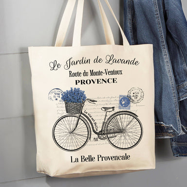 <p>Go green with our French Purple Lavender Bicycle tote bag! Made from 100% cotton canvas, our charming hand-drawn print is perfect for groceries and travel. It's also washable and reusable, making it an eco-friendly choice. Carry your essentials with style and sustainability in mind with this 12 oz canvas tote bag.</p> <p>Details:</p> <ul> <li>12 oz</li> <li>16" X 15" x 3"</li> <li>20" self fabric handles</li> </ul>