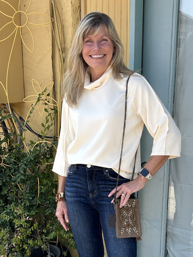 Stay cozy and stylish all year long with our Funnel Neck Top! The cream color, unique seam detailing, and soft material make it a great staple piece for any wardrobe. The funnel neck and 3/4 sleeves add a touch of elegance, while also providing a seamless transition from fall to winter to spring.&nbsp;

Material: 49% Polyester / 45% Rayon / 6% Spandex

Instructions: Gentle cool hand wash, dry flat