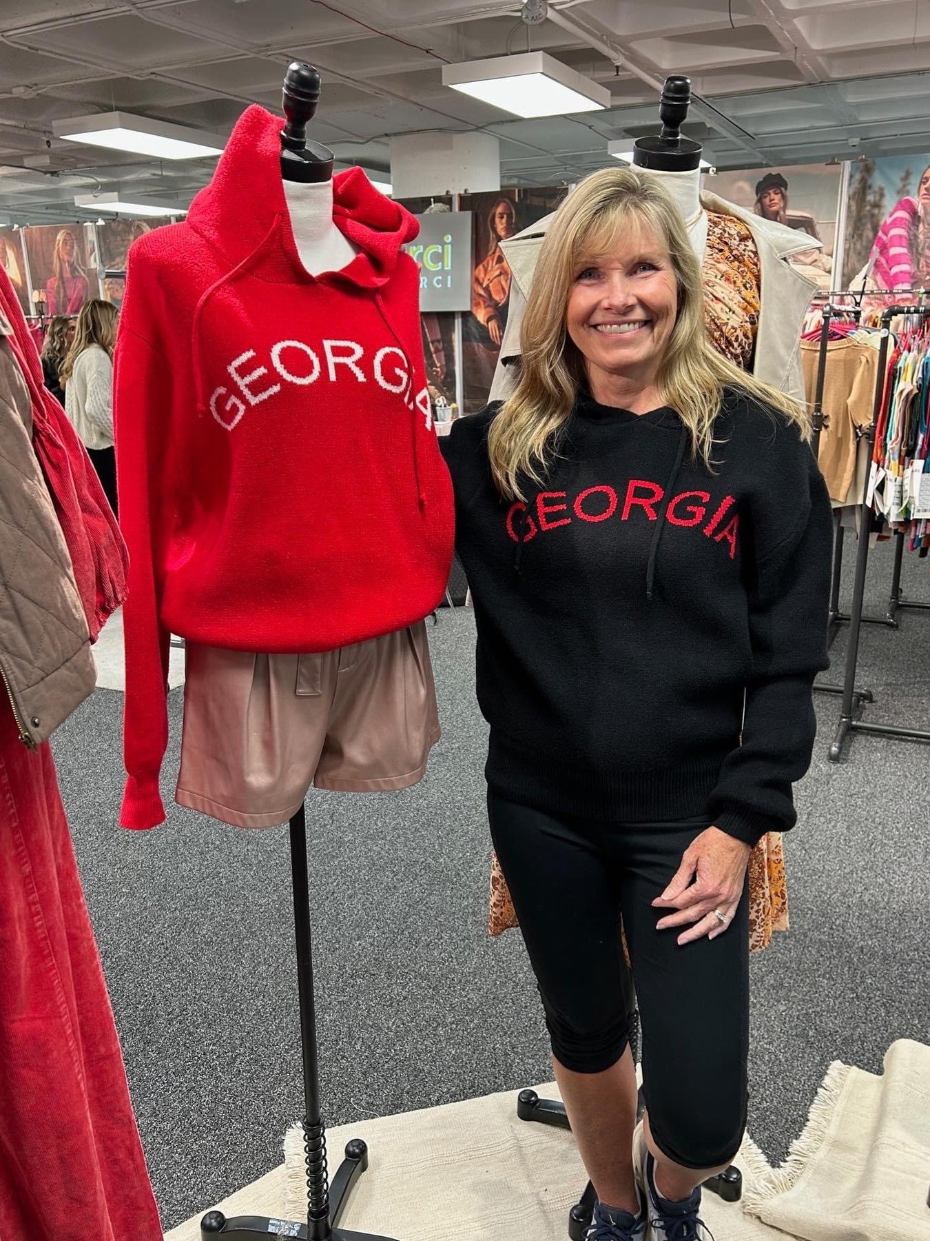 The Georgia Sweater is make of the softest yarn, has a hood and is so stinkin' cute! Who can resist sharing our love for the Dawgs in a bold, yet subtle way!?  The sweater is available in red and in black. It runs true to size.   Carolee and the mannequin are wearing a small.   Material: Made of 43% Viscose, 35% nylon, 22% polyester.  Care Instructions: Hand wash cold and line dry.