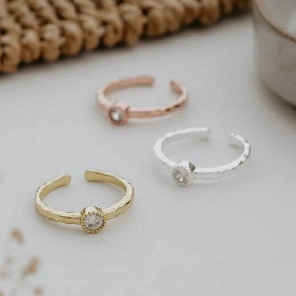 Add a touch of elegance and versatility to any outfit with our adjustable ring. The sweet and simple design is perfect for everyday wear, but can also make a statement on special occasions. Embrace the beauty and charm of our cubic zirconia stone.  Details:   adjustable to fit most made with cubic zirconia silver or gold plated hypoallergenic - no nickel/lead anti-tarnish coated