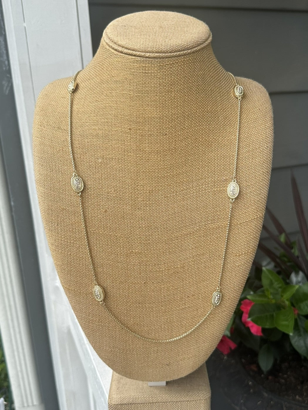 This long necklace combines understated sophistication with eye-catching sparkle. Oval crystal accents add dimension and light-reflecting beauty to an otherwise minimal design, creating a piece that works with virtually any outfit. Whether worn layered with other pieces or as a standalone statement, it brings refined elegance to your jewelry collection.

Approximate length: 35-37"