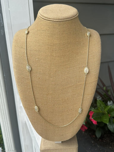 This long necklace combines understated sophistication with eye-catching sparkle. Oval crystal accents add dimension and light-reflecting beauty to an otherwise minimal design, creating a piece that works with virtually any outfit. Whether worn layered with other pieces or as a standalone statement, it brings refined elegance to your jewelry collection.

Approximate length: 35-37"