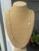 This long necklace combines understated sophistication with eye-catching sparkle. Oval crystal accents add dimension and light-reflecting beauty to an otherwise minimal design, creating a piece that works with virtually any outfit. Whether worn layered with other pieces or as a standalone statement, it brings refined elegance to your jewelry collection.

Approximate length: 35-37"