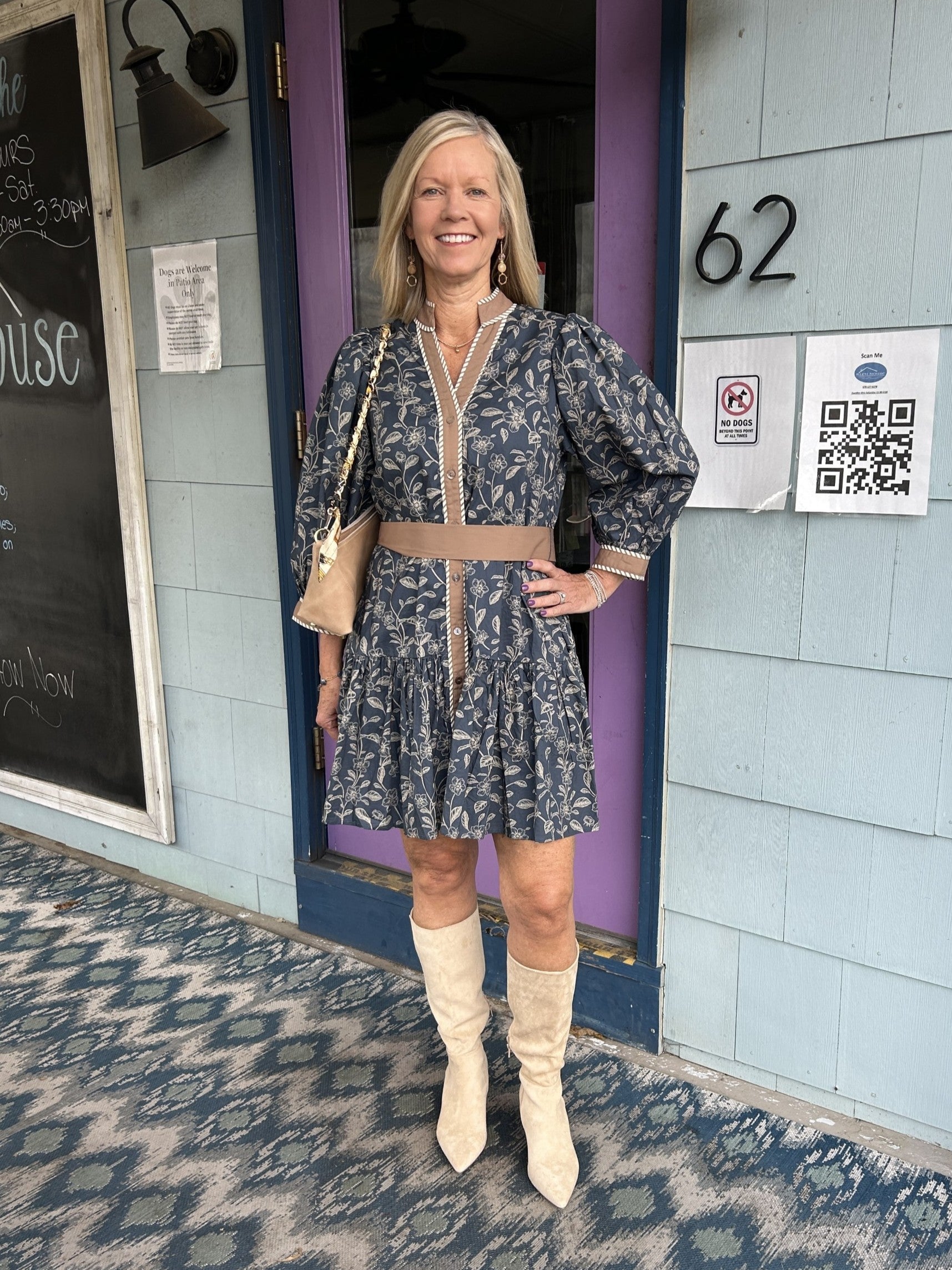 Discover timeless style with this stunning floral dress that combines comfort and sophistication. The midnight blue background showcases delicate floral patterns beautifully framed by dark khaki accents. With a convenient button-up front and tie waist, you'll enjoy both ease of wear and a customizable fit that flatters your figure. The lined construction ensures durability and comfort, while the short length and long sleeves make this versatile piece perfect for transitioning between seasons. Whether you're