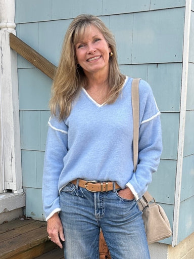 This medium-weight V-neck pullover sweater in a beautiful light blue shade features contrasting cream trim and stylish off-the-shoulder sleeves. Its versatile design lets you wear it alone for a chic look or easily layer it for added warmth and style.

Material: 60% Polyester / 25% Polyamide / 15% Wool

Care Instructions: Dry clean only