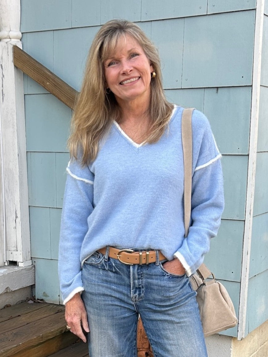 This medium-weight V-neck pullover sweater in a beautiful light blue shade features contrasting cream trim and stylish off-the-shoulder sleeves. Its versatile design lets you wear it alone for a chic look or easily layer it for added warmth and style.

Material: 60% Polyester / 25% Polyamide / 15% Wool

Care Instructions: Dry clean only