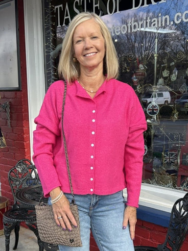 This stunning hot pink button-down is the ultimate wardrobe essential. Lightweight and incredibly versatile, wear it buttoned up as a sweater, or as a cardigan over your favorite tank. The vibrant color instantly elevates any outfit, making it perfect for creating multiple looks from one piece. Comfortable enough for everyday wear, polished enough for any occasion.

Material: 82% Polyester / 15% Acrylic / 3% Spandex

Care Instructions: Hand wash cold, line dry
