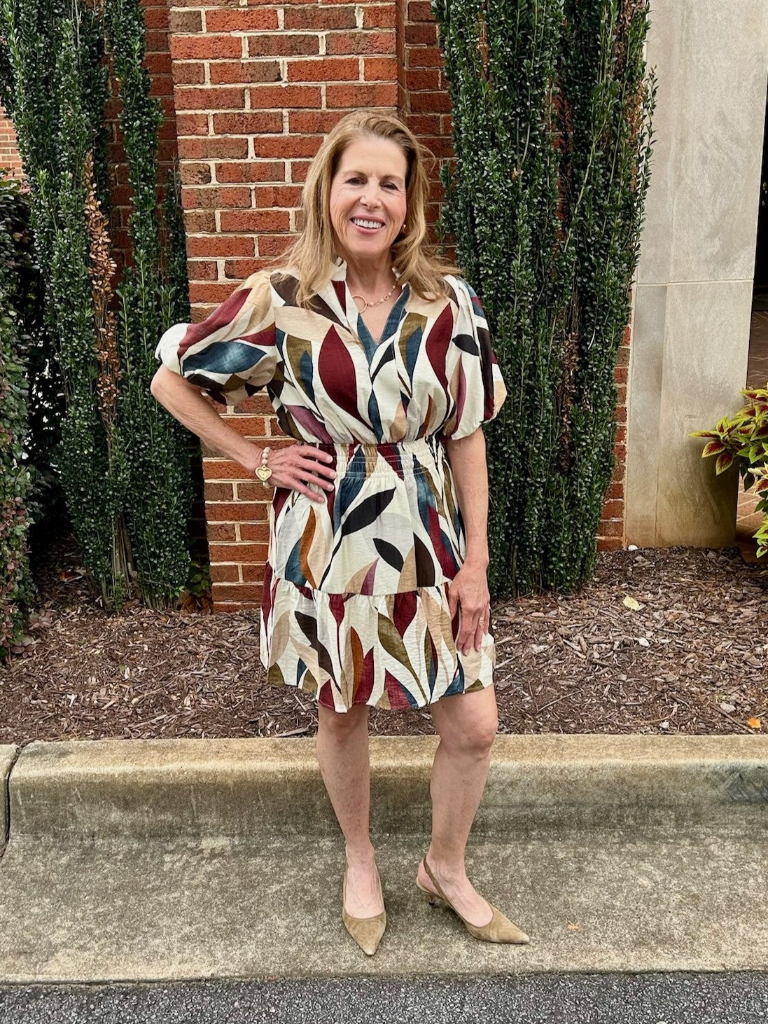 This Puff Sleeve Tiered Short Dress features a flattering cinched waist and charming puffed sleeves that add volume and elegance. Its lined fabric ensures comfort, while the V-neck with a placket collar offers a polished look. Perfect for fall, it showcases a gorgeous seasonal print that complements any wardrobe with ease. Ideal for gatherings or casual outings.

Barbara is wearing a size Small.

Material: 80% Rayon / 20% Nylon

Care Instructions: Gentle cool hand wash, dry flat