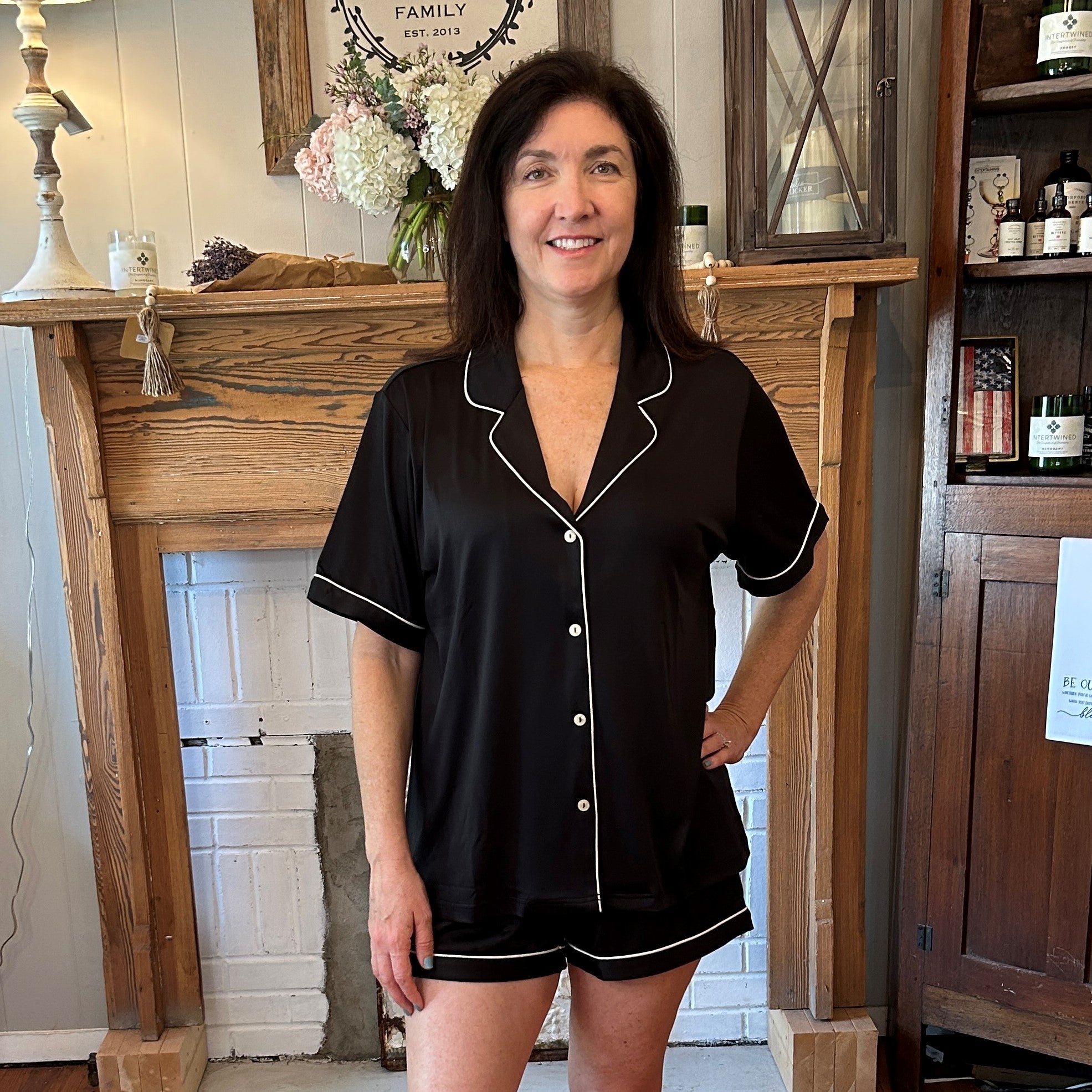 This Women's Knit Pajama Short Set offers luxurious comfort and convenience. Made with soft slinky jersey material, this set includes a matching button-up shirt and shorts with an elastic waistband and functioning drawstring for a custom fit. It has white piping for extra flare. Enjoy a comfortable night of rest in style.