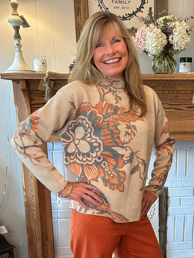 Freshen up your wardrobe with this simple Floral Mock-Neck Sweater. Crafted with a comfortable mock-neck design and adorned with a colorful beige, sage, and orange floral pattern, this cozy sweater will elevate your look with a stylish and elegant touch. Perfect for any occasion.  Material: 55% Viscose / 45% Nylon  Care Instructions: Hand wash separately in cold water, lay flat to dry