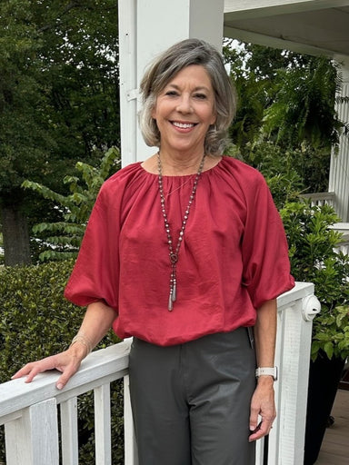 Our Puffed Sleeve Blouse comes in a beautiful burgundy color.&nbsp; It has 3/4 length puffed sleeves and an elastic waistband. It's short, but not cropped, hitting at the hips.

Material: 90% Tencel / 10% Polyester

Care Instructions: Gentle cool hand wash, dry flat