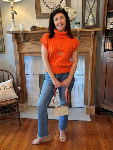 This Turtleneck Capped Sleeve Sweater is the perfect way to transition into fall! It's orange cable knit material make it the ideal piece for any football season wardrobe. Plus, it's turtleneck and banded waist will make you stand out in any crowd! #gameon  Material: 60% Acrylic / 4% Rayon  Care Instructions: Hand wash cold