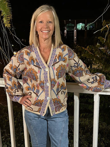 This versatile sweater transforms effortlessly—wear it buttoned up for a cozy fit or open like a cardigan for layered style. Featuring a beautiful floral design in warm, fall-inspired colors and a delicate border trim, it adds a soft, inviting touch to any outfit. Perfect for cooler days, its plush fabric promises comfort without sacrificing elegance.

Material: 36% Acrylic / 30% Nylon / 28% PBT / 6% Wool

Care Instructions: Hand wash separately in cold water, lay flat to dry