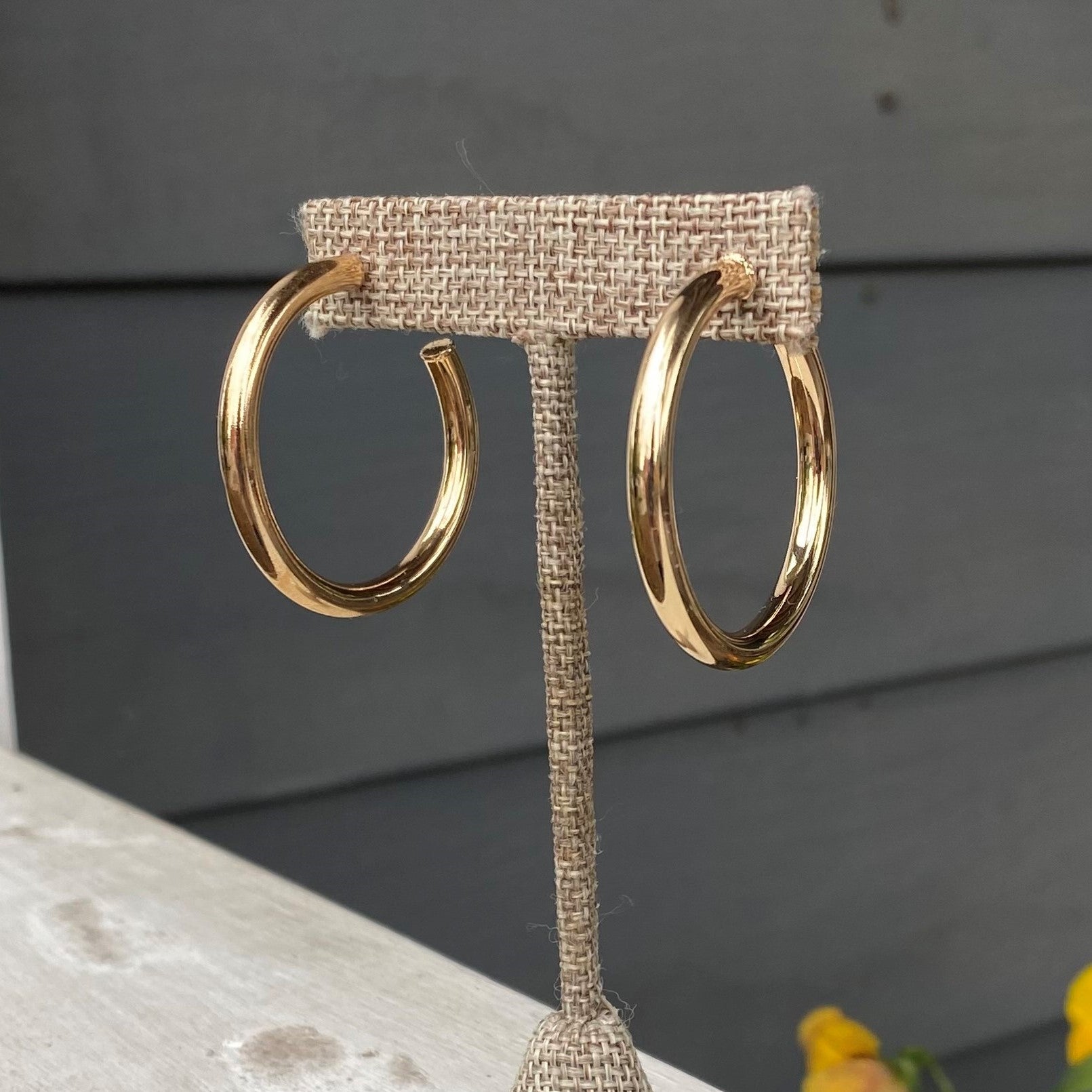These stunning 1.5" Shinny Gold Hoop Earrings add a classic and sophisticated touch to every outfit. Gold with a shinny finish, these earrings are perfect for everyday wear.