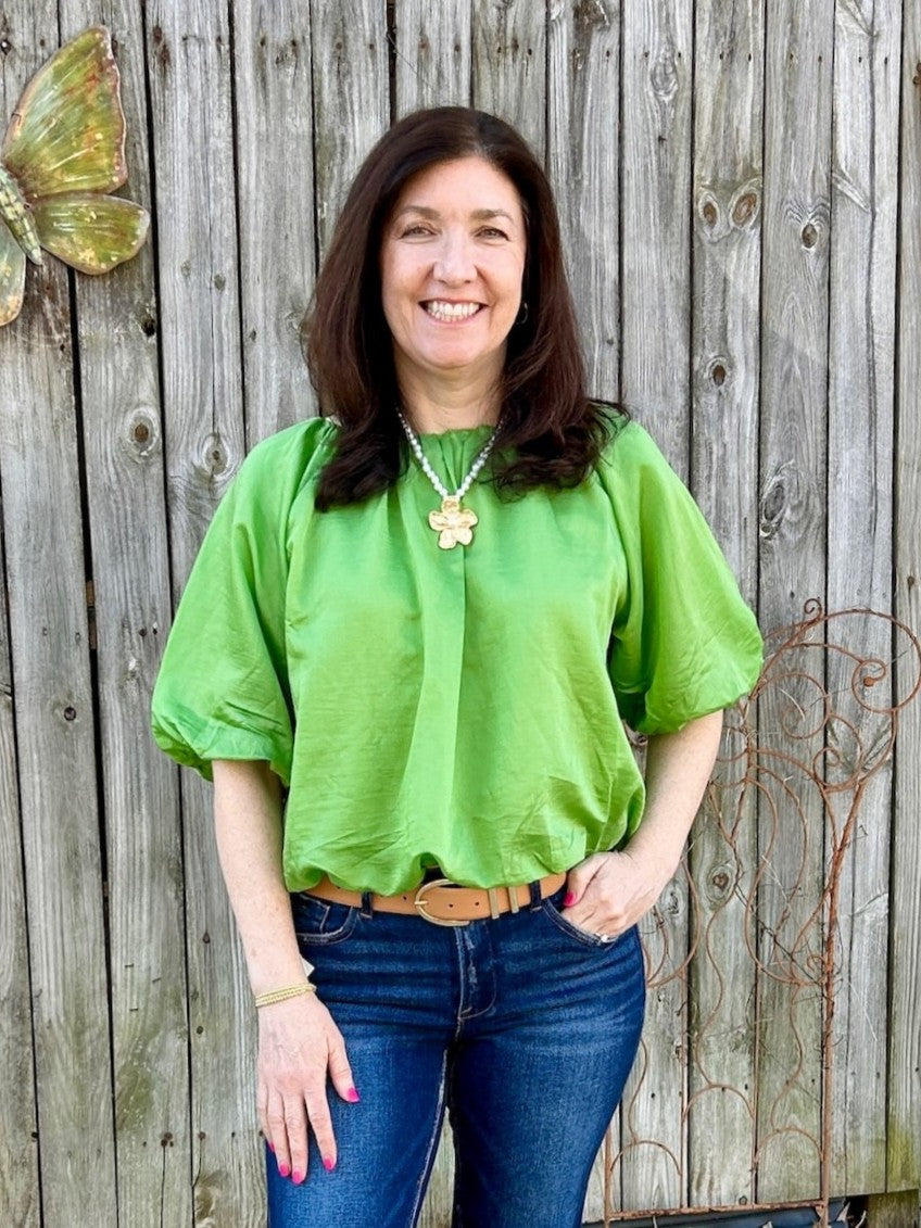 Our Puffed Sleeve Blouse comes in a beautiful pear green color - perfect for Spring.&nbsp; It has 3/4 length puffed sleeves and an elastic waistband. It's short, but not cropped, hitting at the hips.

Tara is wearing a size Medium.

Material: 90% Tencel / 10% Polyester

Care Instructions: Gentle cool hand wash, dry flat