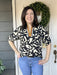 Start your fall style with this Short Sleeve Modern Design Top, featuring a striking front placket that draws attention. Its modern black and cream print offers a chic, versatile look, while the short sleeves with elastic cuffs provide comfort and a flattering fit.

Material: 83% Rayon / 17% Nylon

Care Instructions: Gentle cool hand wash, dry flat