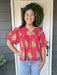 This Puff Sleeve Front Tie Top features charming puffed short sleeves and a gathered bodice that flatters every figure. The cute front tie with tassels adds a playful touch, set against a vibrant red background adorned with a beautiful floral print. Perfect as a stylish transition piece, it effortlessly bridges warm summer days into crisp fall evenings.

Material: 100% Cotton

Care Instructions: Gentle cool hand wash, dry flat