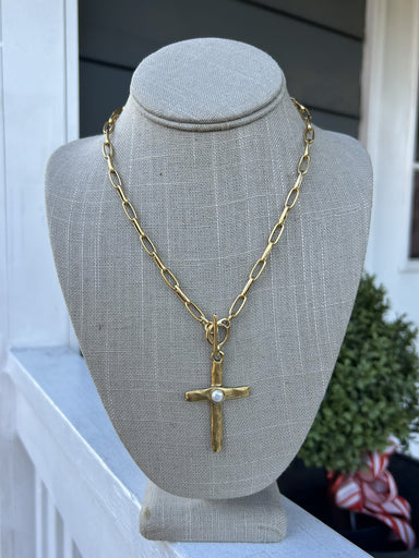 Make a meaningful statement with this captivating cross pendant necklace. The elongated chain provides an elegant silhouette, while the intricately hammered cross pendant commands attention with its textured artistry. A delicate pearl accent adds timeless grace to this devotional piece. The front T-bar clasp offers convenient accessibility, so you can wear it with confidence throughout your day. Whether you're seeking spiritual expression or a sophisticated accessory, this stunning necklace delivers both be