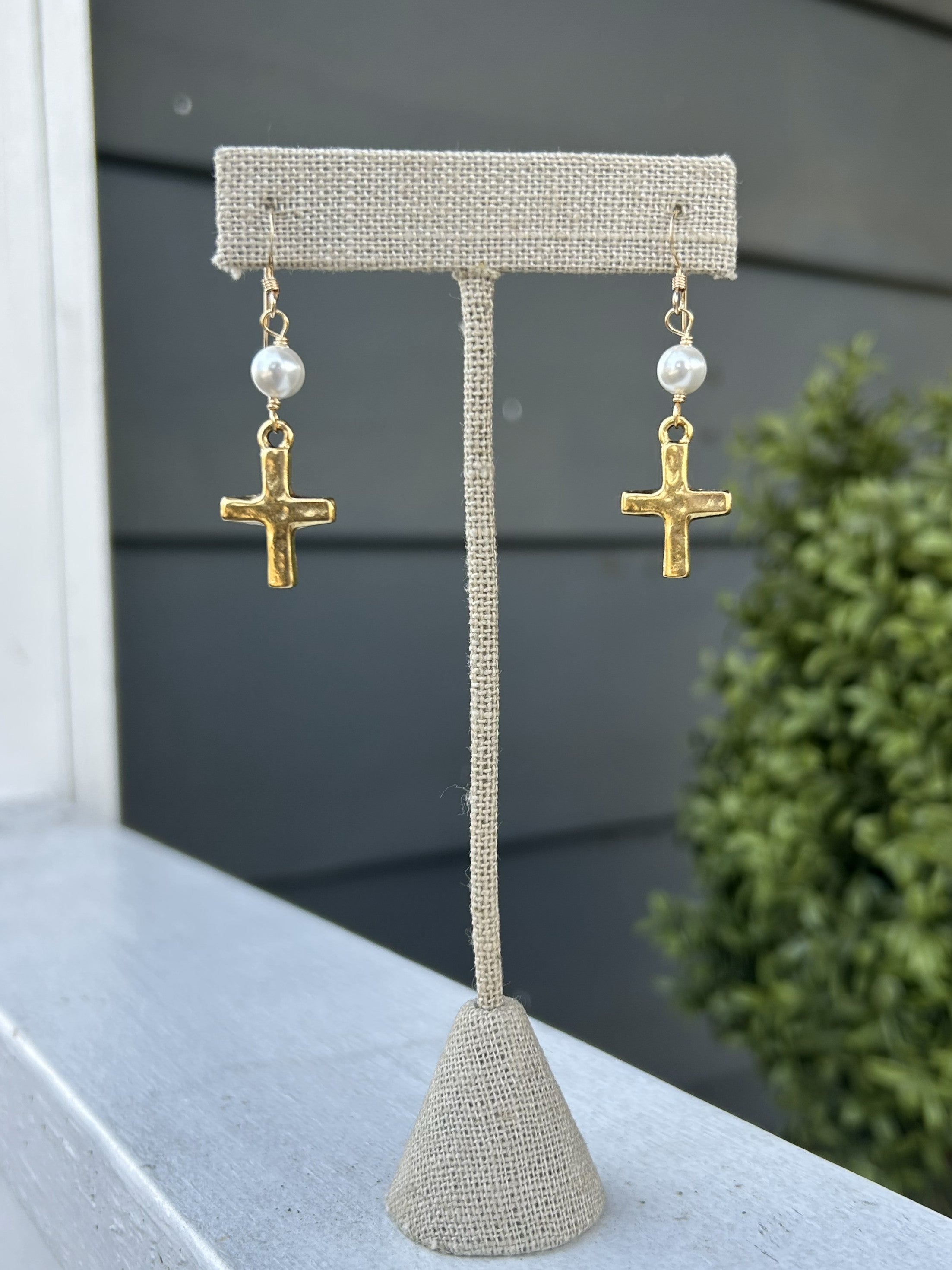Delicate hammered cross earrings that become an instant staple in your jewelry collection. Each pair is topped with a beautiful pearl accent, creating a lovely, understated elegance that works beautifully with any outfit. Simple yet sophisticated, these earrings bring a touch of refined grace to your everyday style.