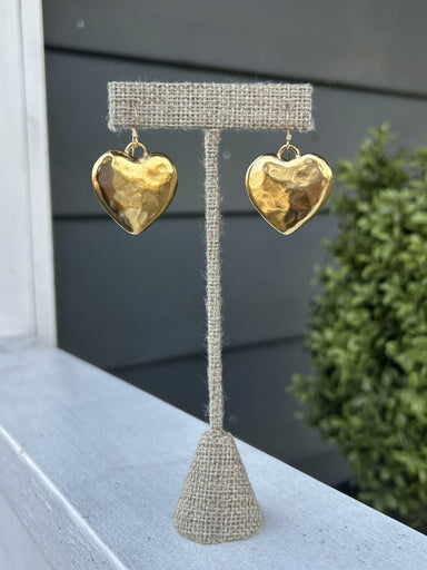Add a touch of elegance to any outfit with our beautiful Hammered Heart Earrings. These versatile earrings are perfect for both dressy and casual occasions, making them a must-have in your jewelry collection. The unique hammered design adds a touch of texture and style!

The heart is approximately 1" x 1" in size.