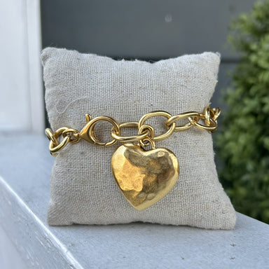This chain bracelet commands attention with its larger links and artisan-crafted hammered heart charm. Whether you're building a layered bracelet stack or showcasing it as a standalone piece, its versatile design adapts to your personal style. From everyday wear to special occasions, this bracelet transitions seamlessly across your wardrobe, making it the kind of investment piece you'll reach for again and again.