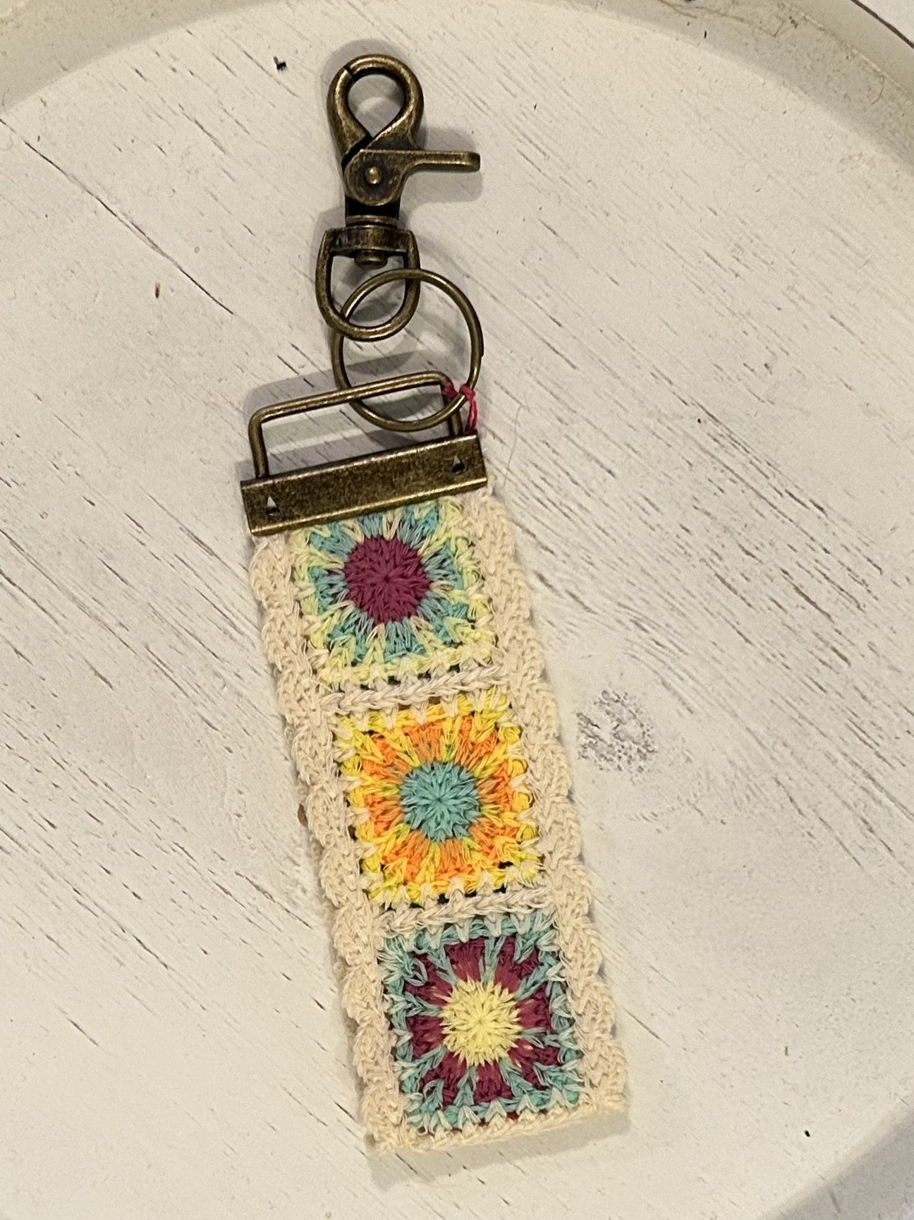 Keep your keys close and your style even closer with our adorable Crochet Key Fobs! Designed with convenience in mind, these key chains are perfect for carrying on your wrist while running errands. The clip and key ring make it easy to keep track of your essentials, while the embroidered designs add a playful and festive touch.

Details:

Loop fits comfortably around your wrist. Features antiqued brass key ring and lobster clasp to easily clip to your bag or belt loop
Cotton, metal