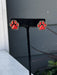 Show your team spirit with these Game Day Red &amp; Black Paw Post Earrings. Featuring a charming paw print, these earrings are perfect for game day celebrations and showing your pride year-round. The classic post style offers comfortable, everyday wear while making a spirited statement. Whether you're cheering from the stands or showing support around town, these fun earrings bring playful team pride to any outfit.